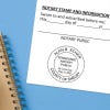 Notary public stamp impression on signed document above notebook