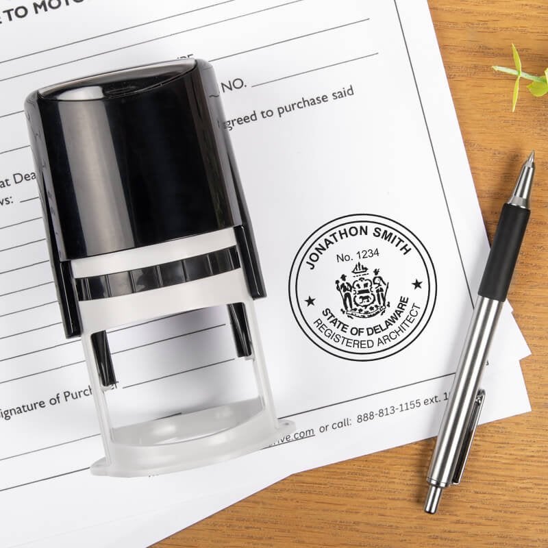 A self-inking stamp and a pen placed next to the State of Delaware Architect Seal
