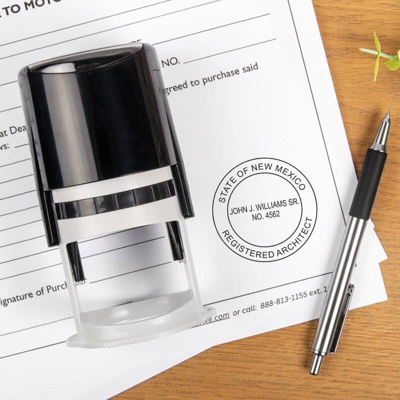 A self-inking stamp and a pen placed next to the State of New Mexico Architect Seal