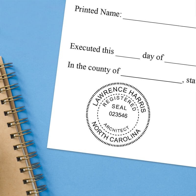 North Carolina architect stamps impression on official document with custom seal design.  