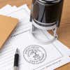 A self-inking stamp placed next to the State of Tennessee Architect Seal at the bottom of a document