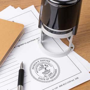 A self-inking stamp placed next to the State of Tennessee Architect Seal at the bottom of a document