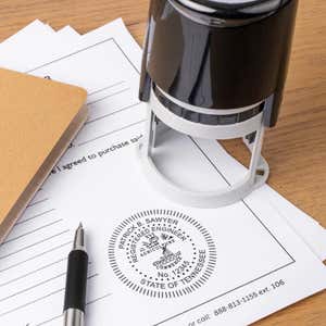 The State of Tennessee Engineer Seal on a document next to the stamp body standing upright