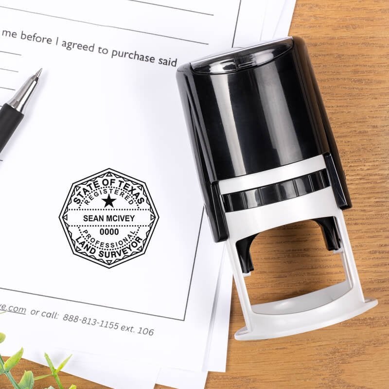 Texas land surveyor stamp in use on a document, showing an octagonal seal next to a self-inking stamp and a pen on a desk.
