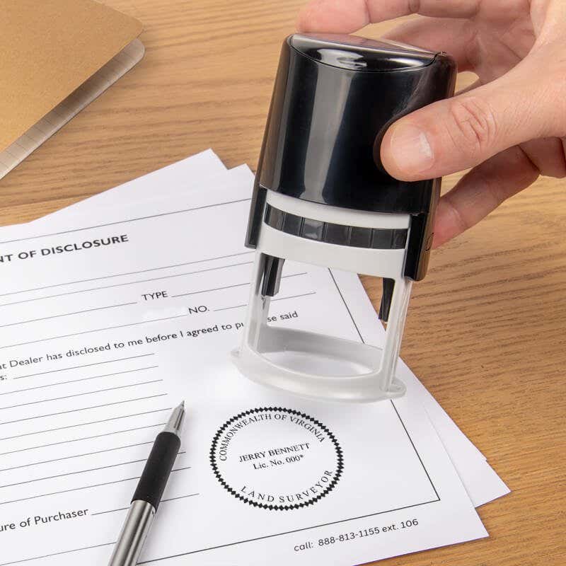 The State of Virginia Land Surveyor Seal being used on a document with a self-inking stamp