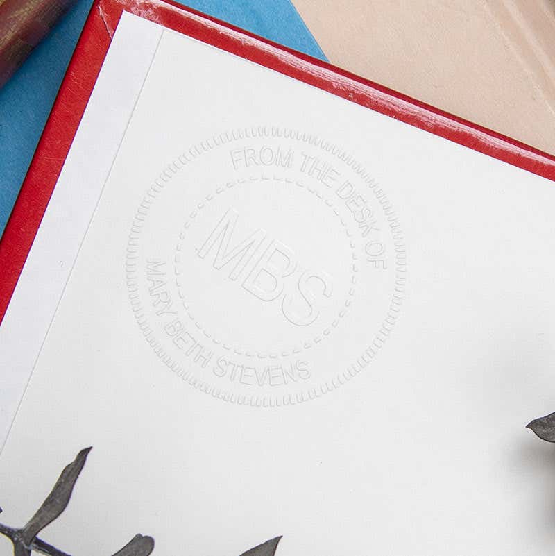 Example of custom Initial Embosser impression on the inside of a book