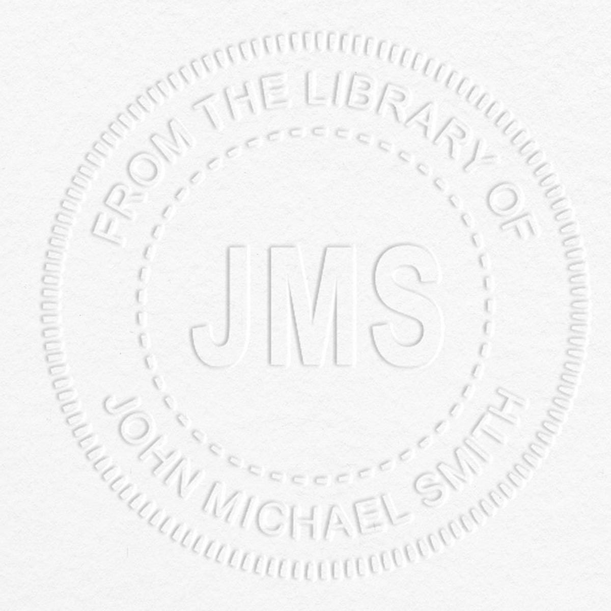 Example of From the Library Initials Personalized Book Embosser Imprint on grey paper