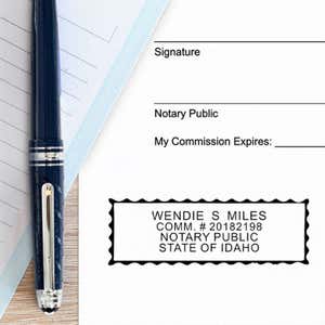 Impression on paper next to a pen for the Idaho Notary Pink Stamp - Rectangle