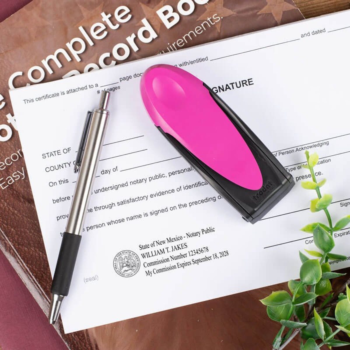 New Mexico Pink Rectangle Notary Pocket Stamp Closed on a Document