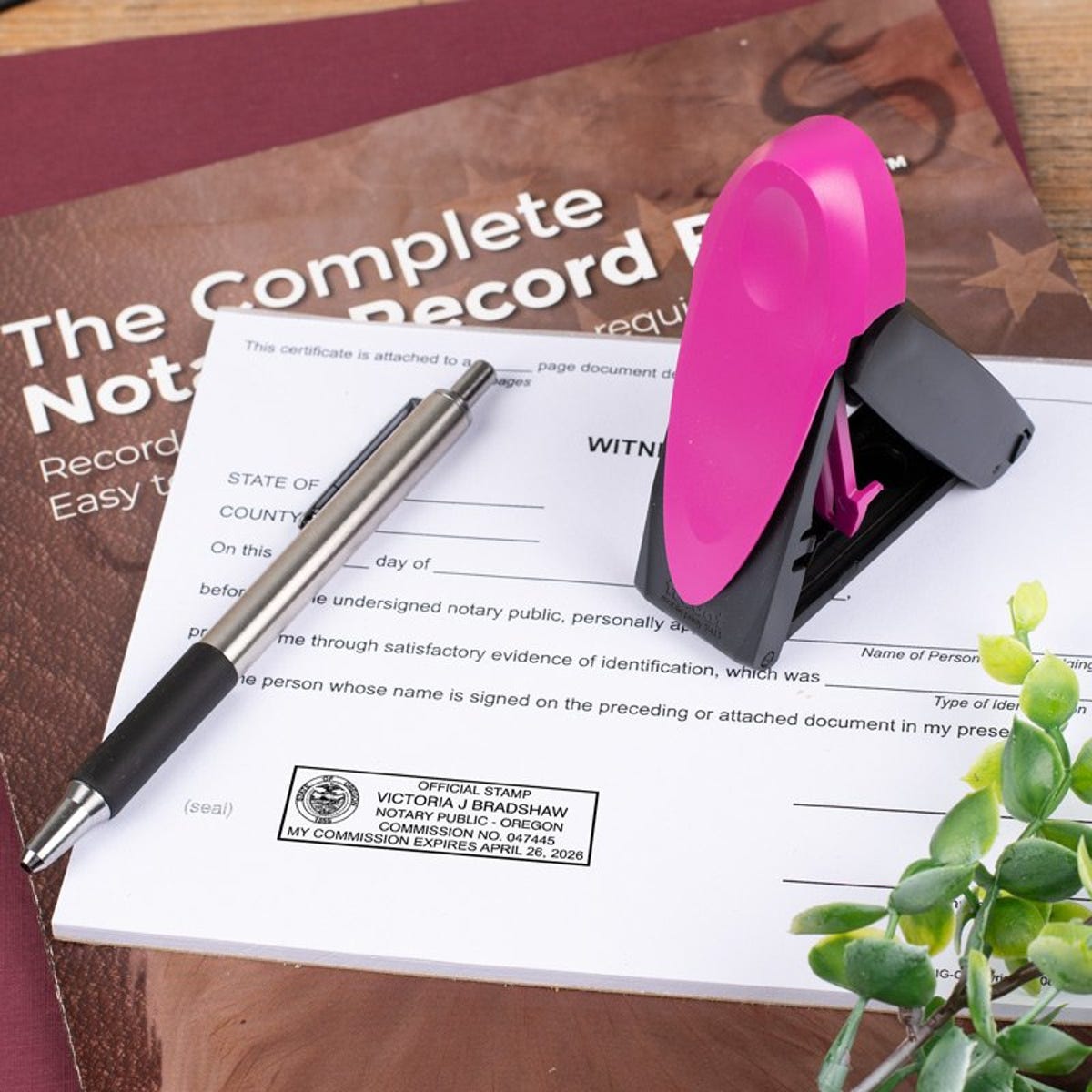 Oregon Notary Pink Stamp Next to Impression on Document