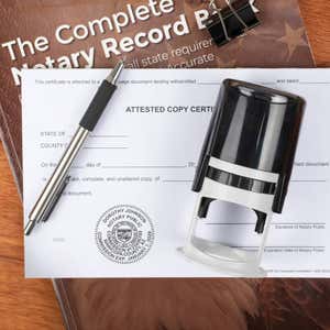 Arizona notary stamp on form with pen and record book on wood surface.