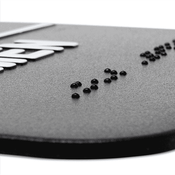Close up of the Braille on an ADA sign