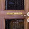1x8 custom engraved brass sign displayed on a door