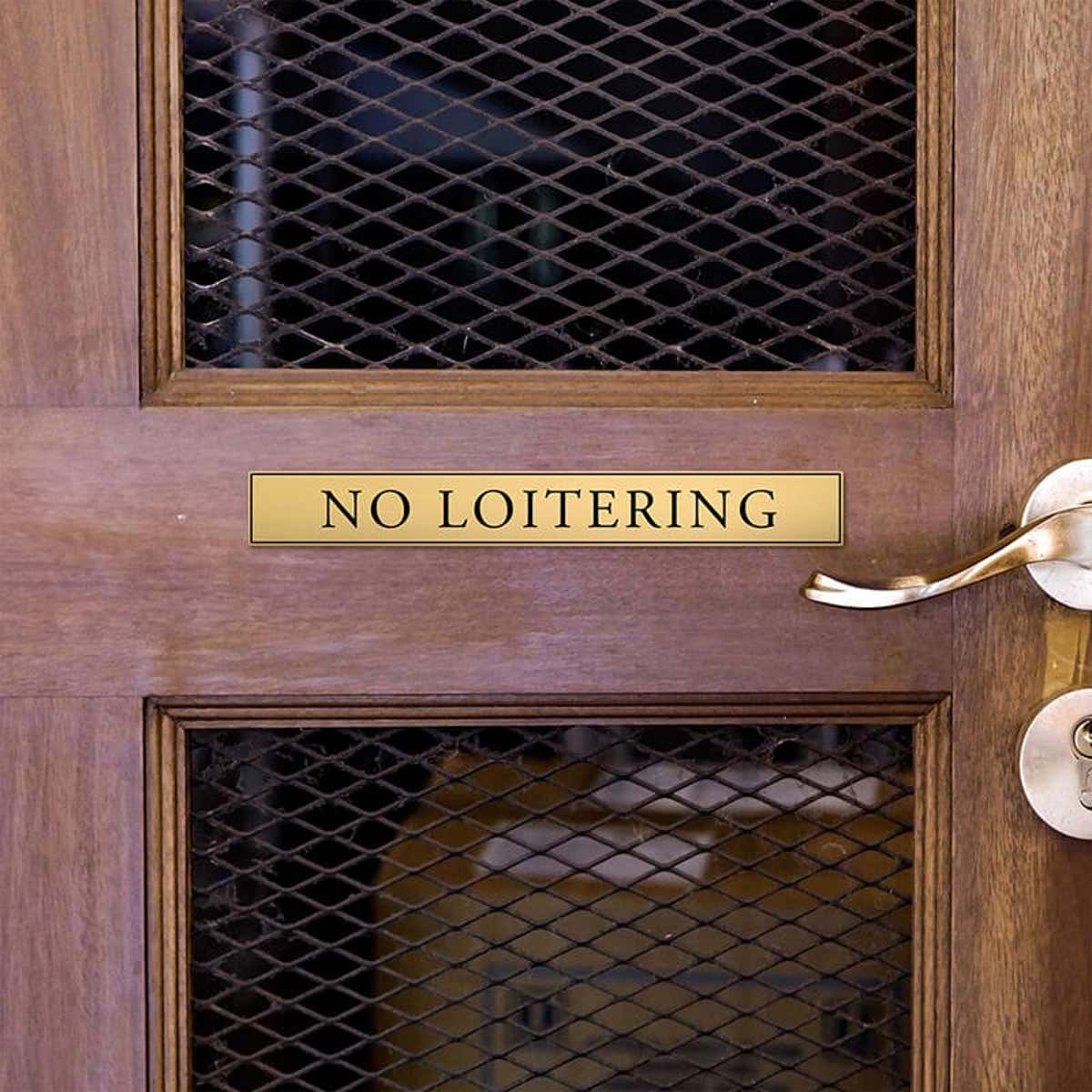 1x8 custom engraved brass sign displayed on a door