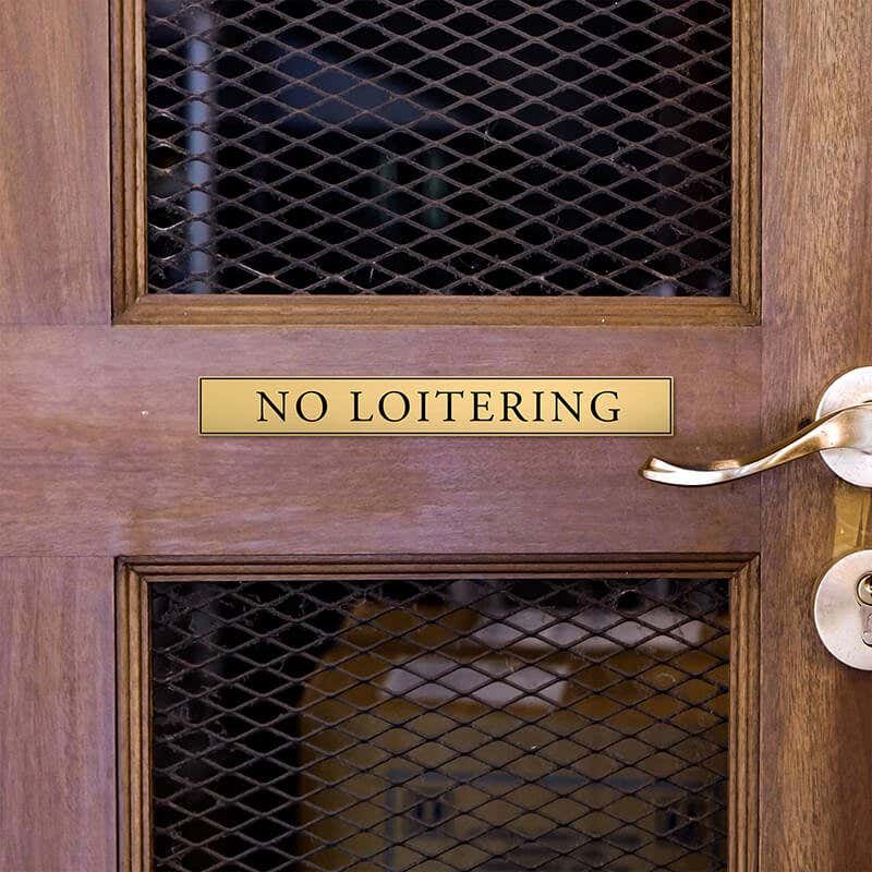 1x8 custom engraved brass sign displayed on a door