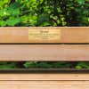 2x6 custom engraved brass sign displayed on a bench