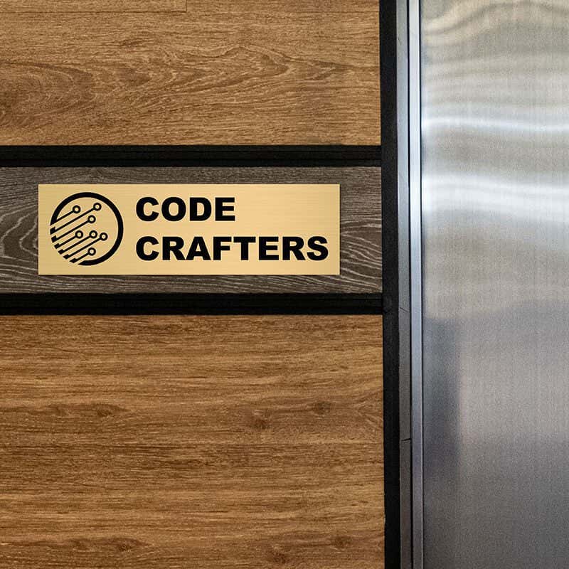 3x10 custom engraved brass sign displayed on a wall