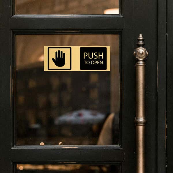 3x8 custom engraved brass sign displayed on a door