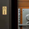 2x1 custom engraved brass sign displayed by a door