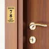 4x2 custom engraved brass sign displayed by a door
