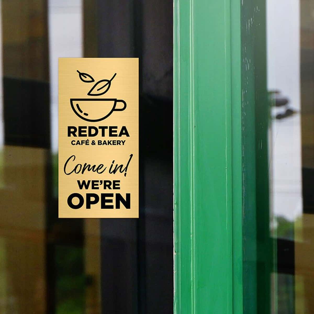 6x3 custom engraved brass sign displayed on a window