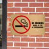 12x20 printed brass sign displayed on a brick wall