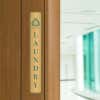 14x2 printed brass sign displayed by a doorway