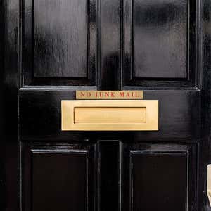 1x8 printed brass sign displayed on a door