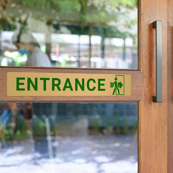 2x12 printed brass sign displayed on a front door