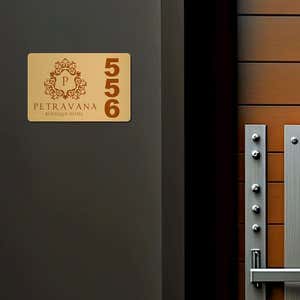 2x3 printed brass sign displayed next to a doorway