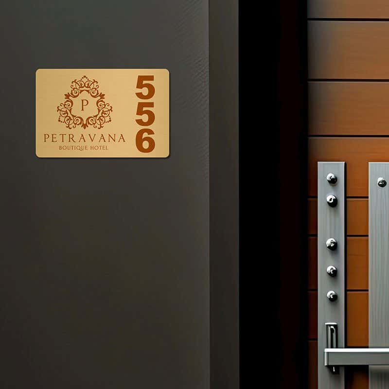2x3 printed brass sign displayed next to a doorway