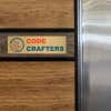 3x10 printed brass sign displayed on a wooden wall