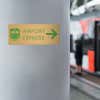 4x10 printed brass sign displayed by a train station