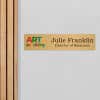 4x18 printed brass sign displayed by a doorway