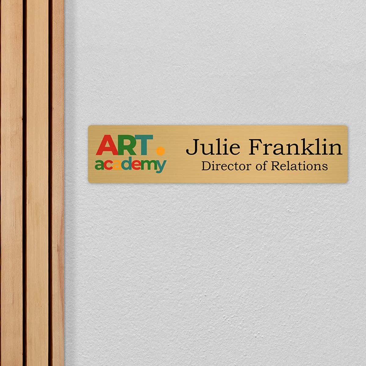 4x18 printed brass sign displayed by a doorway