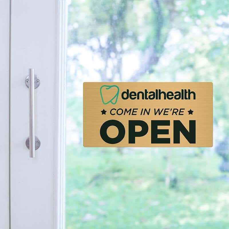 4x8 printed brass sign displayed on a glass door