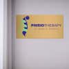 6x12 printed brass sign displayed by a doorway