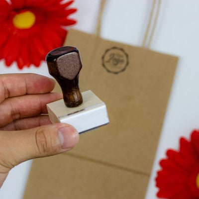 Example of 1 inch custom logo stamp with bag in background