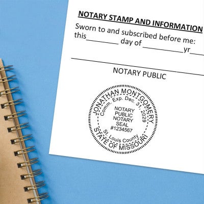 Stamped notary acknowledgment form on blue folder with notary seal.