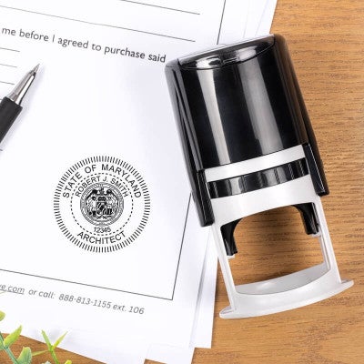 Maryland architect stamp impression on document beside self-inking stamp and pen.