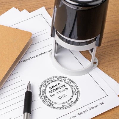 The State of Nevada Engineer Seal on a document next to a self-inking stamp