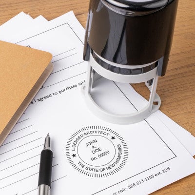 The State of New Hampshire Architect Seal at the bottom of a document with the self-inking stamp and a pen