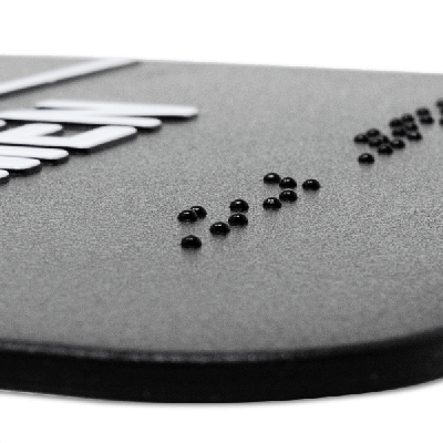 Close up on the braille on the ADA restroom sign