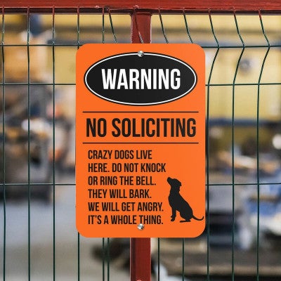 A Warning No Soliciting Aluminum Sign in Orange 
