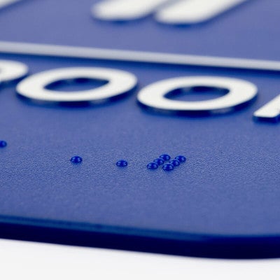 Close up of the Braille on the sign