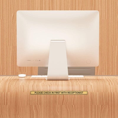 1x16 custom engraved brass sign displayed on a desk