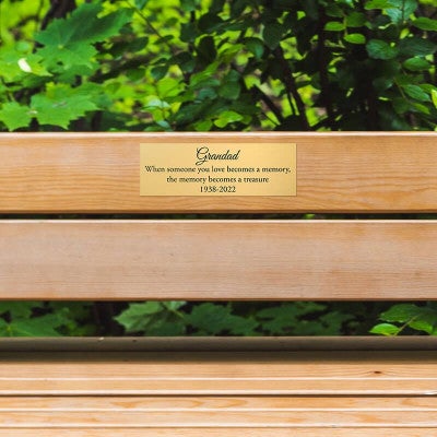 2x6 custom engraved brass sign displayed on a bench
