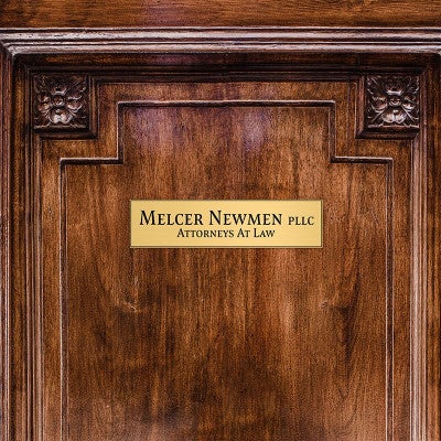 2x8 custom brass sign displayed on a door