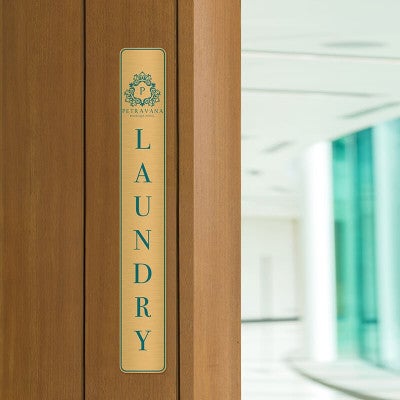 14x2 printed brass sign displayed by a doorway