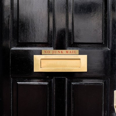 1x8 printed brass sign displayed on a door